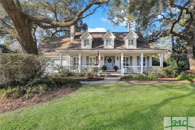 view of front facade featuring covered porch, a front yard, and a garage