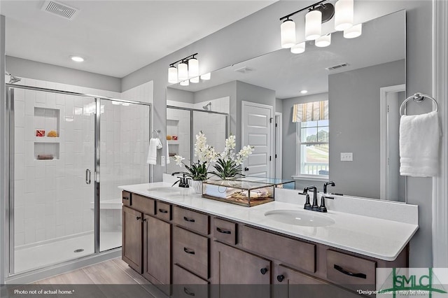 full bathroom featuring a stall shower, visible vents, and a sink