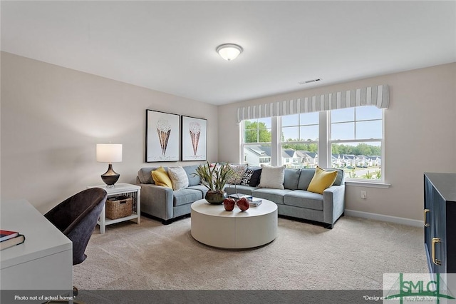 living room with light carpet, visible vents, and baseboards