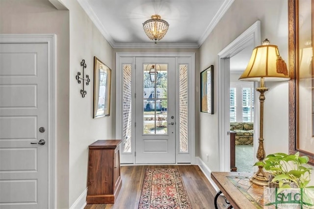 entryway featuring crown molding, baseboards, a wealth of natural light, and wood finished floors