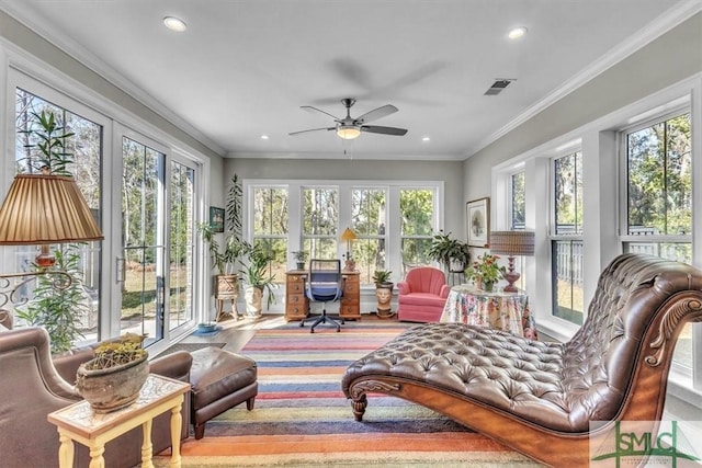 sunroom / solarium with visible vents and a ceiling fan