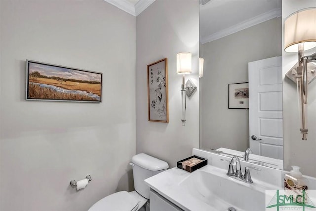 bathroom featuring vanity, toilet, and crown molding