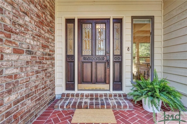 property entrance with brick siding