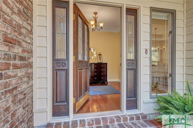 doorway to property featuring brick siding