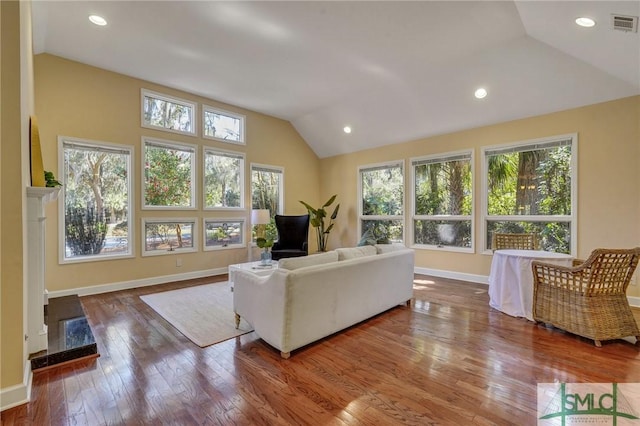 living room featuring recessed lighting, wood-type flooring, visible vents, vaulted ceiling, and baseboards