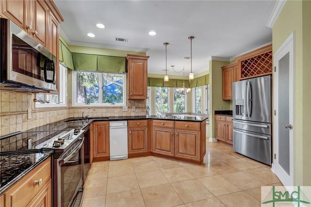 kitchen with crown molding, tasteful backsplash, visible vents, appliances with stainless steel finishes, and a peninsula