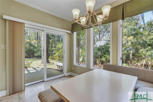 unfurnished dining area with light tile patterned floors, ornamental molding, and a notable chandelier