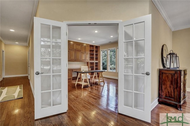 interior space featuring dark wood-style flooring, french doors, recessed lighting, ornamental molding, and baseboards