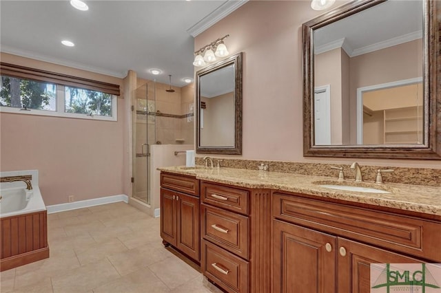 bathroom featuring a shower stall, double vanity, a sink, and crown molding