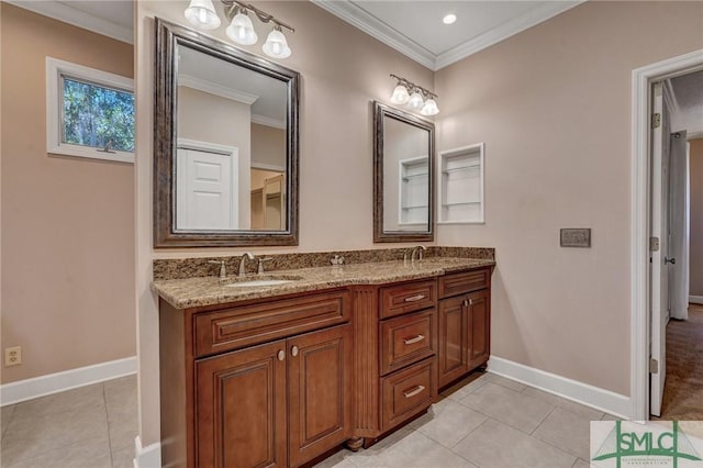 bathroom with baseboards, a sink, and crown molding