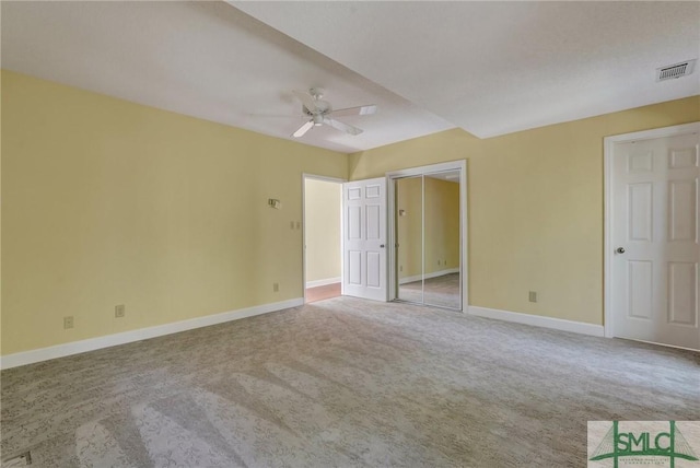 unfurnished bedroom with ceiling fan, carpet floors, visible vents, baseboards, and a closet