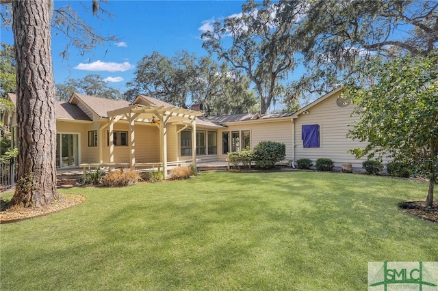 back of property featuring a lawn and a pergola