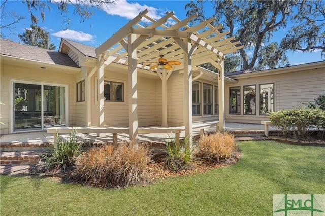 back of house featuring ceiling fan, a lawn, a wooden deck, and a pergola