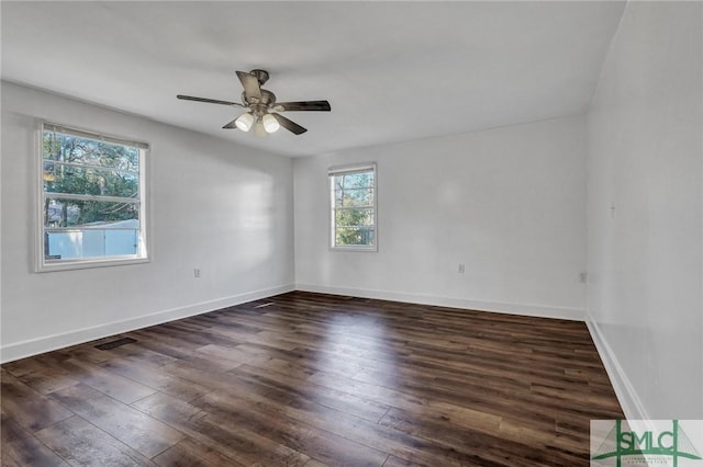 spare room with ceiling fan, hardwood / wood-style floors, visible vents, and baseboards