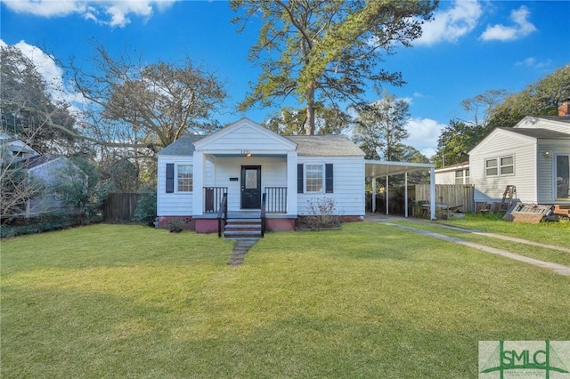 bungalow-style home featuring a carport, fence, and a front lawn