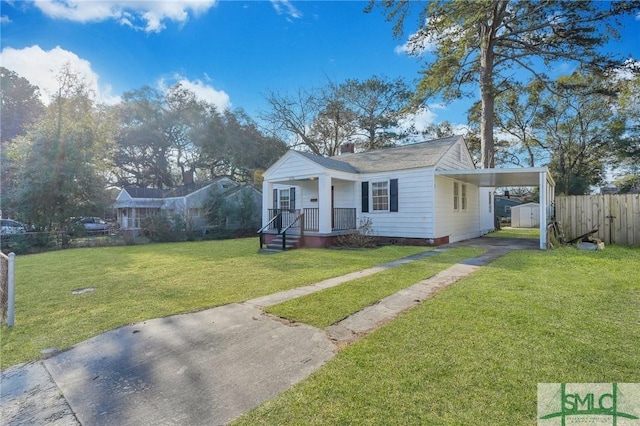 bungalow-style home with driveway, fence, a carport, and a front yard