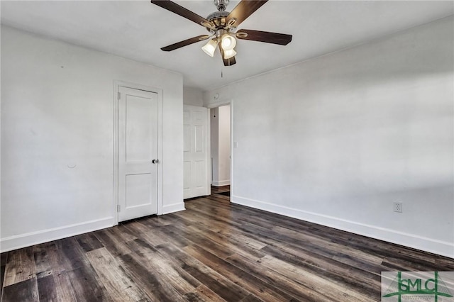 unfurnished bedroom featuring ceiling fan, dark wood-type flooring, and baseboards