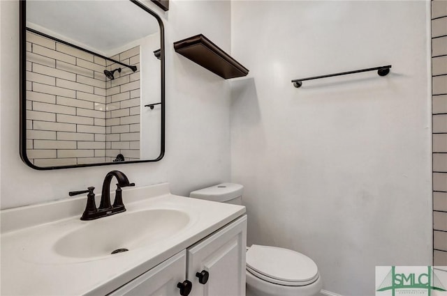 full bath with vanity, toilet, and walk in shower