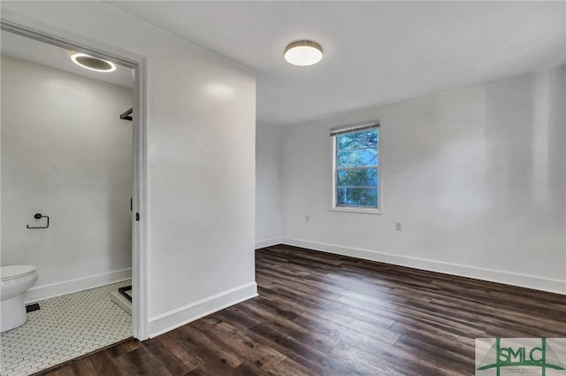 bathroom featuring wood finished floors, toilet, and baseboards