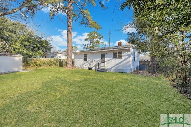 view of yard featuring entry steps and fence