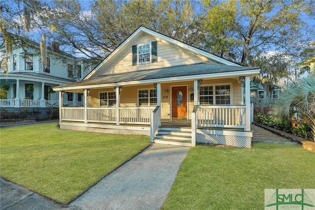 view of front of house with a porch and a front yard