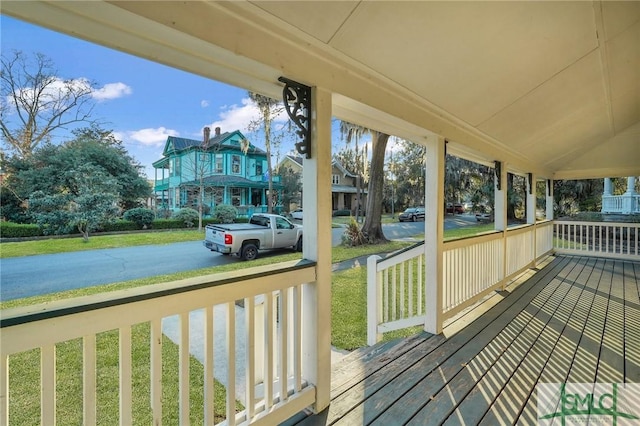 wooden terrace featuring covered porch