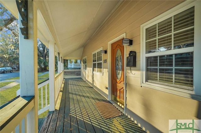 wooden terrace with a porch