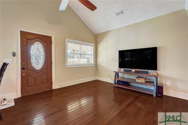 foyer featuring lofted ceiling, visible vents, hardwood / wood-style floors, ceiling fan, and baseboards