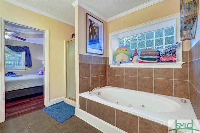 ensuite bathroom with a textured ceiling, a shower stall, tile patterned flooring, and connected bathroom