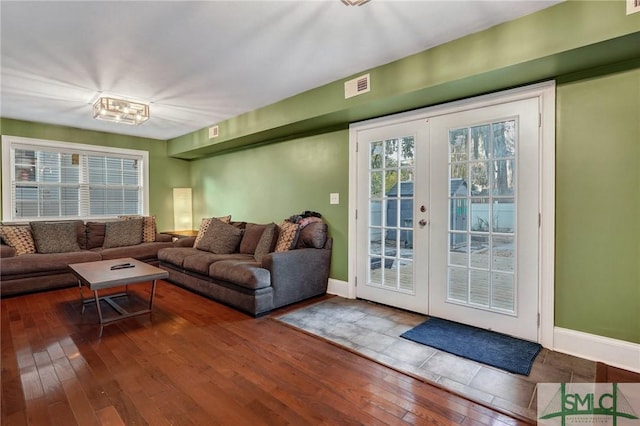 interior space featuring french doors, hardwood / wood-style flooring, visible vents, and baseboards