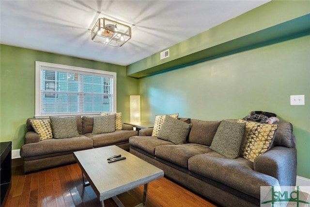 living area featuring wood-type flooring and visible vents