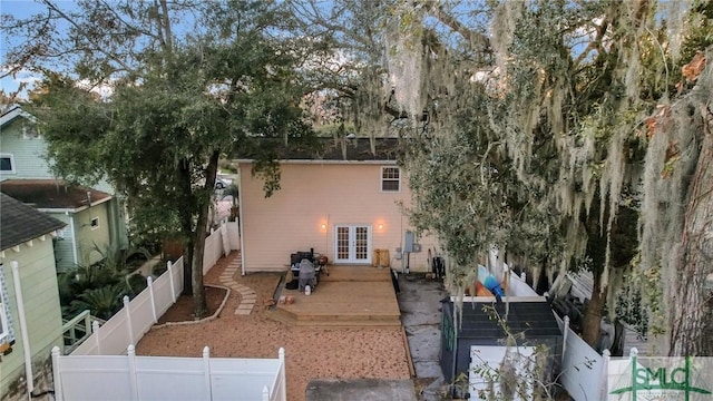 exterior space featuring a fenced backyard, a deck, and french doors