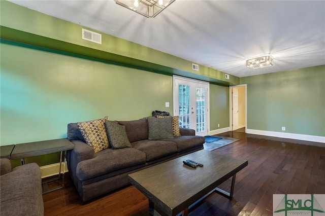 living area with french doors, visible vents, baseboards, and wood finished floors