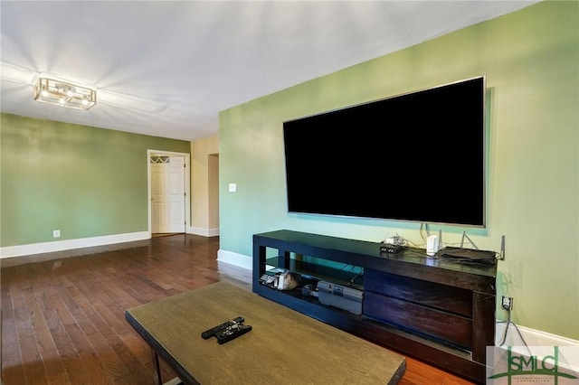 living area with baseboards and hardwood / wood-style floors