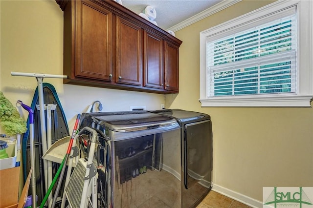 laundry room featuring crown molding, cabinet space, light tile patterned flooring, separate washer and dryer, and baseboards