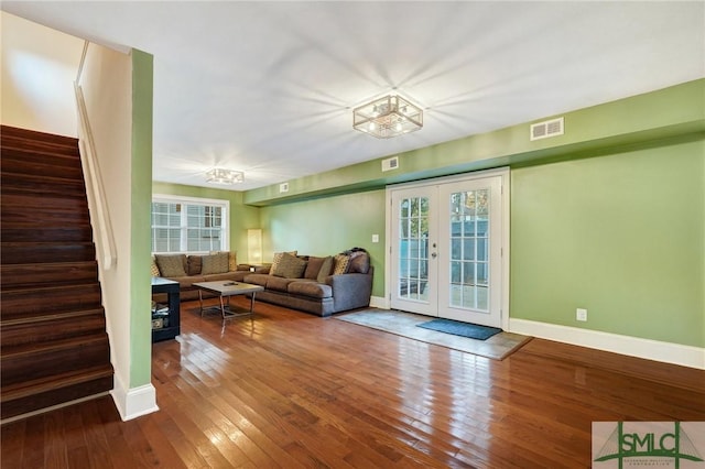 living room with french doors, visible vents, hardwood / wood-style floors, and stairs