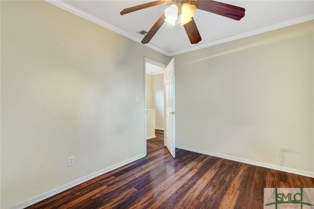 spare room featuring wood finished floors, a ceiling fan, visible vents, baseboards, and ornamental molding