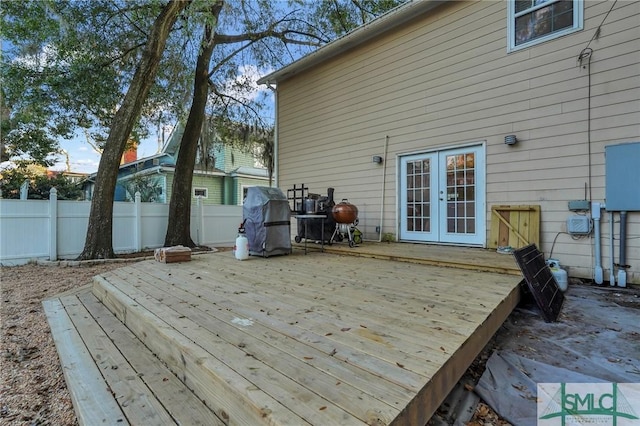 deck with french doors, a grill, and fence