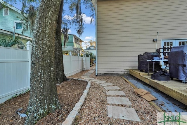 view of yard featuring fence and a deck