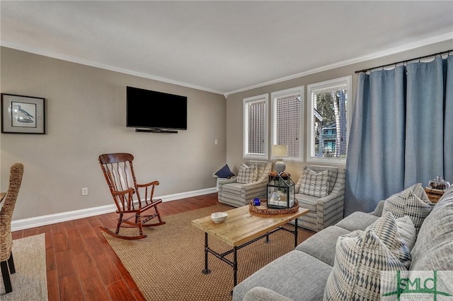 living room featuring baseboards, wood finished floors, and crown molding