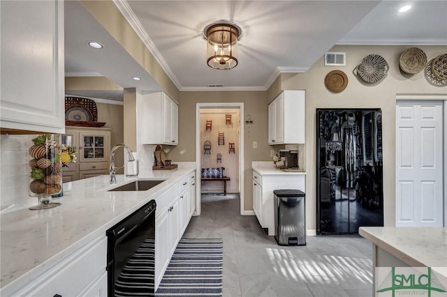 kitchen featuring white cabinetry, visible vents, a sink, and light stone countertops