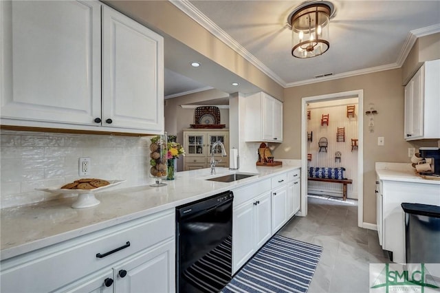 kitchen with ornamental molding, black dishwasher, white cabinetry, and a sink