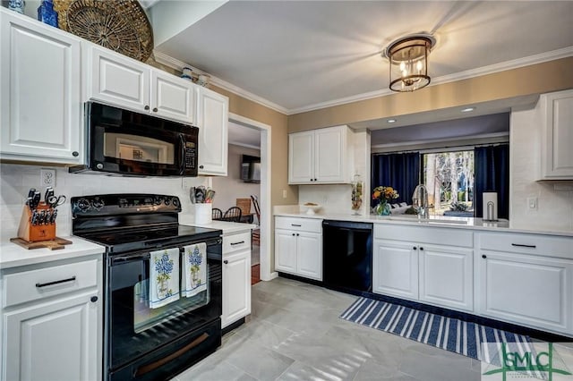 kitchen with black appliances, crown molding, light countertops, and a sink