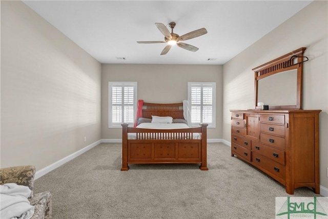 bedroom featuring multiple windows, baseboards, and light colored carpet