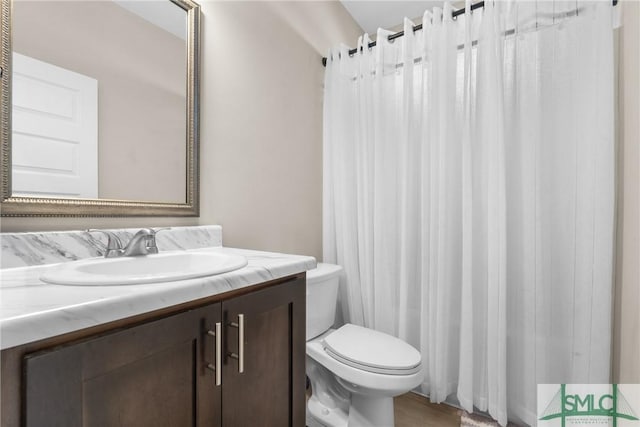 full bathroom with toilet and vanity