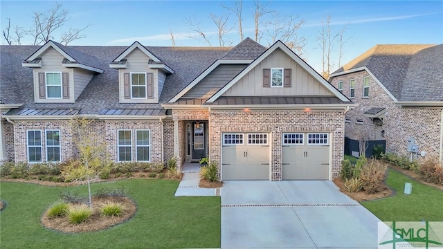 craftsman-style house with concrete driveway, brick siding, a standing seam roof, and a front yard