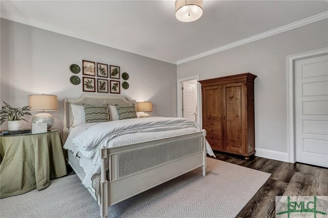 bedroom featuring ornamental molding, baseboards, and wood finished floors