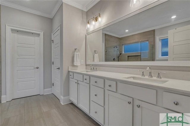 bathroom with crown molding, double vanity, a sink, and a shower stall