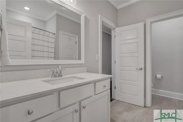 bathroom with toilet, baseboards, crown molding, and vanity