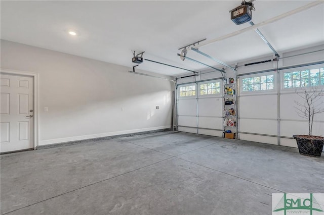 garage with baseboards and a garage door opener